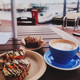 Hummus toast with cucumber, tomato, and balsamic vinegar. Latte and banana muffin.