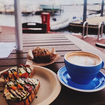 Gilbert's Coffee Bar - Port Salerno - Hummus toast with cucumber, tomato, and balsamic vinegar. Latte and banana muffin. - Coffee & Tea Near Me - Stuart, Florida