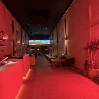 High Desert - a long hallway with red lighting - Lounges Near Me - Los Angeles, California