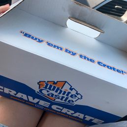 a person holding a box of pizza a person holding a box of pizza