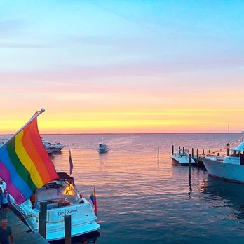 Pines Pantry - a group of people standing on a dock with boats in the water - Grocery Near Me - Fire Island Pines, New York Pines Pantry - a group of people standing on a dock with boats in the water - Grocery Near Me - Fire Island Pines, New York