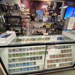 GameRelated - Front counter display case with card options and fun tcg/anime/misc themed items