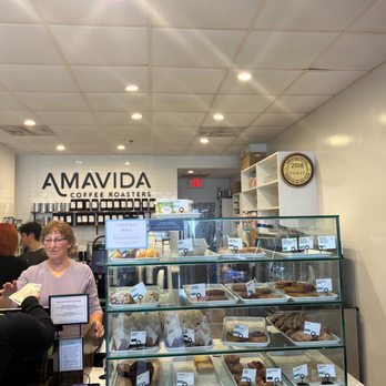 Amavida Coffee Roasters - a woman standing in front of the counter - Coffee & Tea Near Me - Seaside, Florida