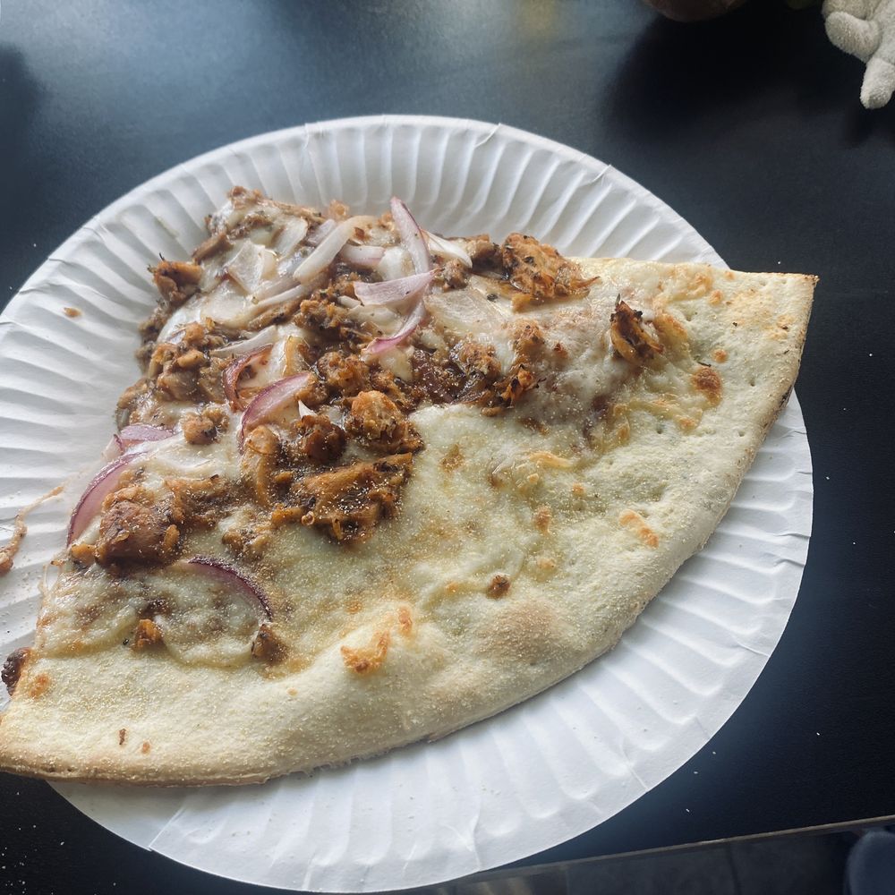 a slice of pizza on a paper plate a slice of pizza on a paper plate