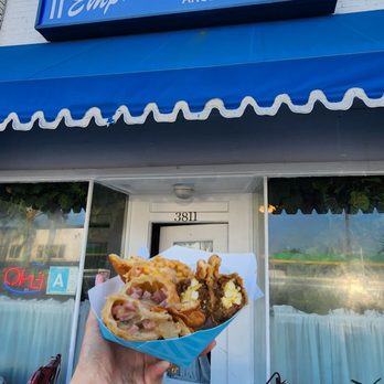 Empanada's Place - a person holding a plate of food - Argentine Near Me - Los Angeles, California