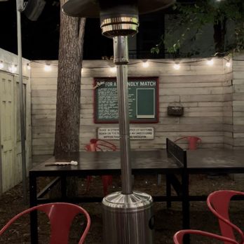 Home Slice Pizza - The outside area all lit up! Ping-pong tables and little benches to sit on! - Pizza Near Me - Austin, Texas