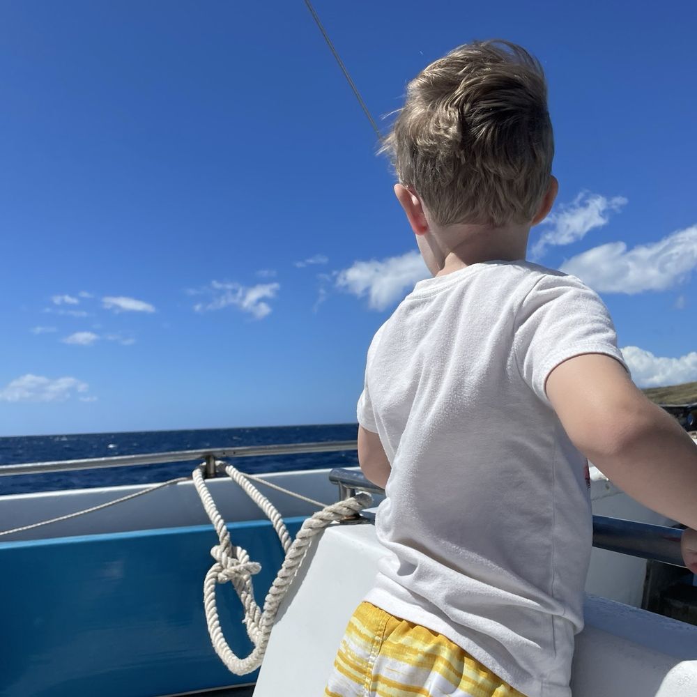 Four Winds Molokini Maui Snorkel Tour - small child looking out over the bow of the boat - Snorkeling Near Me - Maalaea, Hawaii