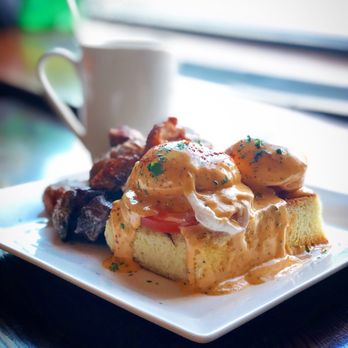 Pequeno Mercat - Mercat Benedict (chorizo, paprika hollandaise, and toasted brioche) with roasted potatoes. Photo by Oanh McClure. - Tapas Bars Near Me - Chicago, Illinois