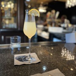 Presidential Lounge - Soixante quinze (French 75) cocktail with bar behind