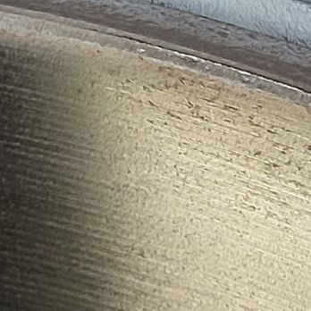 Napleton Auto Group - The image depicts a close-up view of a wooden surface, highlighting the natural grain patterns and texture of the wood. The surface appears to be smooth with visible lines and variations in color, indicating it is a finished piece of wood, potentially part of furniture, flooring, or a similar wooden item. - Car Dealers Near Me - Rosemont, Illinois