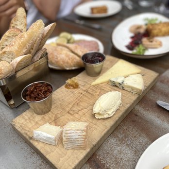 The Amsterdam - a variety of cheeses and breads on a cutting board - New American Near Me - Rhinebeck, New York