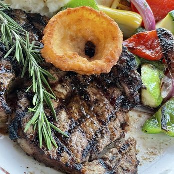 Brews & Barrels - Rib Eye steak with our onion ring appetizer on top - American Near Me - Gaithersburg, Maryland Brews & Barrels - Rib Eye steak with our onion ring appetizer on top - American Near Me - Gaithersburg, Maryland