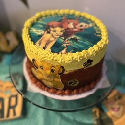 Lion King themed 4 layer cake! Flavor was snickers chocolate cake with peanut butter frosting!