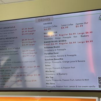 Ranoush - Menu 1/2 - Digital menu board listing a variety of drinks including fruit mocktails, coffee, smoothies, and ice cream. The menu features prices for small, regular, and large sizes, with options like fruit mocktails, Qishta mocktails, avocado mocktails, milkshakes, fresh juice, and ice cream. The display also includes QR code in the bottom right corner for additional information or ordering. - Waffles Near Me - Lexington, Kentucky