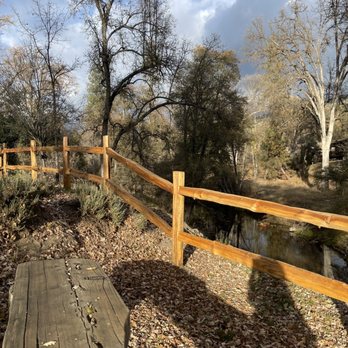 Queen's Inn by the River - Reminder fence to keep walkers away from the bank of the river... erosion might make that first step a doozy! - Wine Bars Near Me - Oakhurst, California Queen's Inn by the River - Reminder fence to keep walkers away from the bank of the river... erosion might make that first step a doozy! - Wine Bars Near Me - Oakhurst, California