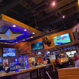 a view of the bar and televisions