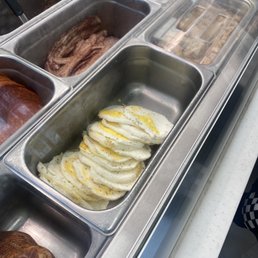 a row of trays of different foods a row of trays of different foods