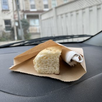 Morso Me - a piece of bread in a paper bag on the dashboard of a car - Pizza Near Me - Toronto, Ontario