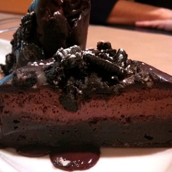 Cedar Street Grille - Triple decker brownie close-up: dense fudge brownie, light chocolate mousse, and oreo-studded chocolate ganache. To die for! - New American Near Me - Sturbridge, Massachusetts