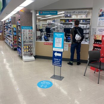 Walgreens - a man standing in a store - Drugstores Near Me - Madison, Wisconsin