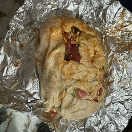 Burrito that became a mess on the foil and the floor after the first bite