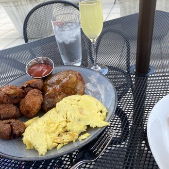 The Bellwether - Pork steak and eggs with a mimosa and water. Balance!! - Cocktail Bars Near Me - St. Louis, Missouri