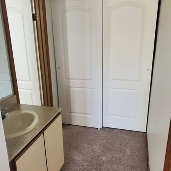 Riverwalk Apartments - Master bedroom with sink and closet - Apartments Near Me - Grand Ledge, Michigan Riverwalk Apartments - Master bedroom with sink and closet - Apartments Near Me - Grand Ledge, Michigan