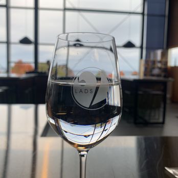 Two Lads Winery - a glass of wine on a table - Wineries Near Me - Traverse City, Michigan Two Lads Winery - a glass of wine on a table - Wineries Near Me - Traverse City, Michigan