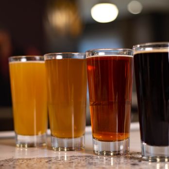 Jackdaw - a row of beer glasses on a counter - New American Near Me - Aurora, Colorado