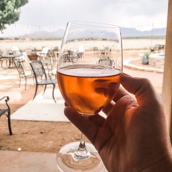 Rio Grande Winery - a hand holding a glass of wine - Wineries Near Me - Las Cruces, New Mexico