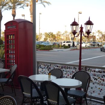 Utopia Caffe - Outside table with the locks like they have in Paris and phone booth like in London. - Breakfast & Brunch Near Me - Tustin, California