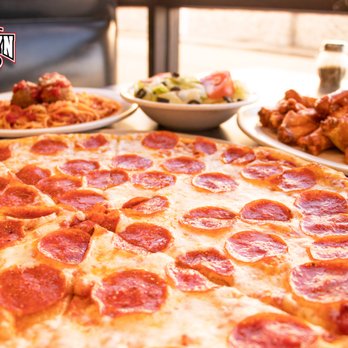 Brooklyn Pizzeria - a pepperoni pizza on a table - Pizza Near Me - Spring, Texas Brooklyn Pizzeria - a pepperoni pizza on a table - Pizza Near Me - Spring, Texas
