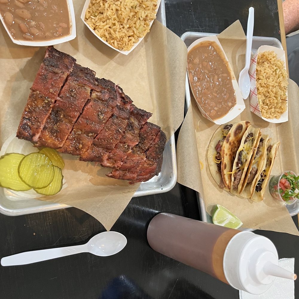 Ribs, pinto beans, Spanish rice, pickles, onions. Brisket taquitos, beans, rice, lime, pico de gallo. BBQ sauce on the side.