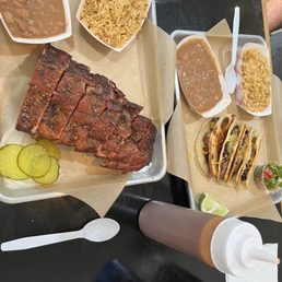 Ribs, pinto beans, Spanish rice, pickles, onions. Brisket taquitos, beans, rice, lime, pico de gallo. BBQ sauce on the side. Ribs, pinto beans, Spanish rice, pickles, onions. Brisket taquitos, beans, rice, lime, pico de gallo. BBQ sauce on the side.