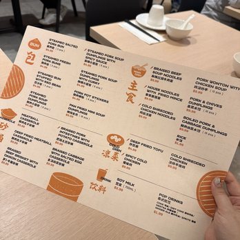 Bao House - a person holding up a menu - Dumplings Near Me - Toronto, Ontario