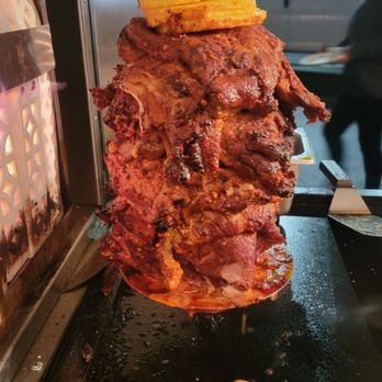 Mando's Grill - a large piece of meat on a skewer - Tacos Near Me - Los Angeles, California
