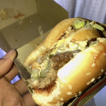 McDonald's - a hand holding a half eaten hamburger - Fast Food Near Me - Las Vegas, Nevada