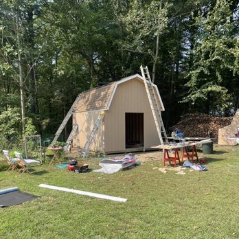Level Up - a shed with a ladder and a ladder - Roofing Near Me