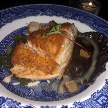 Peter's Inn - Seared Salmon with Pumpkin Ricotta Cocoa Nib Ravioli, Braised Mustard Greens and Apple Cider Butter Sauce - New American Near Me - Baltimore, Maryland