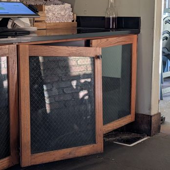 Burger Up - Franklin - Broken falling down cabinet doors in view of dining table. - Burgers Near Me - Franklin, Tennessee