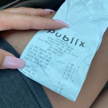 Publix - a woman's hand holding a receipt - Grocery Near Me - Islamorada, Florida