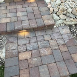 White stain left by the workers after "fixing" the pavers.
