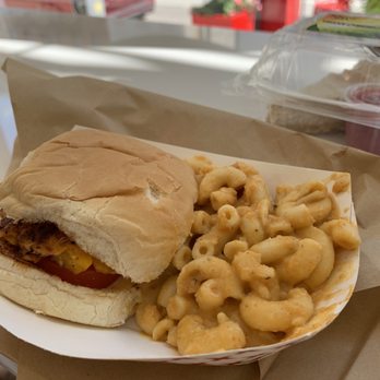 Herban Vegans - Blackened Salm'n Slider and Miracle Mac TM - A sandwich with a bun and visible fillings, served alongside a portion of macaroni and cheese, on a paper tray at a casual dining location. - Vegan Near Me - Cincinnati, Ohio