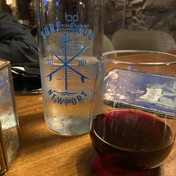 Surf Club - a glass of wine and a bottle of water - Cocktail Bars Near Me - Newport, Rhode Island Surf Club - a glass of wine and a bottle of water - Cocktail Bars Near Me - Newport, Rhode Island