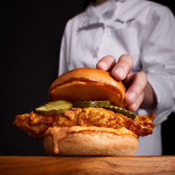 Wings and Rings - a chef holding a sandwich - Chicken Wings Near Me - Weslaco, Texas Wings and Rings - a chef holding a sandwich - Chicken Wings Near Me - Weslaco, Texas