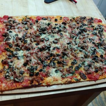 Mezza Luna - Sausage pizza with mushrooms, olives, Parmigiano Reggiano, spicy oil, tomatoes, and Salerno cheese - Cooking Schools Near Me - Montreal, Quebec Mezza Luna - Sausage pizza with mushrooms, olives, Parmigiano Reggiano, spicy oil, tomatoes, and Salerno cheese - Cooking Schools Near Me - Montreal, Quebec