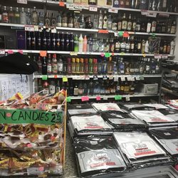 Some of the T-shirts and liquor behind the counter for sale