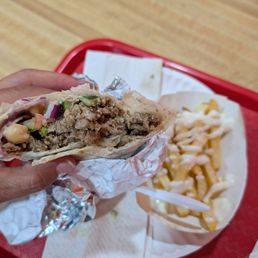 Beef Shawarma with hummus, red onions, chickpeas and tomato cucumber and parsley. With Garlic sauce and Tahini Sauce. Beef Shawarma with hummus, red onions, chickpeas and tomato cucumber and parsley. With Garlic sauce and Tahini Sauce.