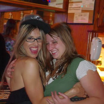 The Britisher - two women hugging at a bar - Pubs Near Me - Lancaster, California