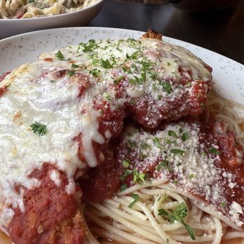 Valentino’s Pasta and Wine - Chicken Parmesan on a bed of spaghetti with marinara - Italian Near Me - Ottawa, Illinois Valentino’s Pasta and Wine - Chicken Parmesan on a bed of spaghetti with marinara - Italian Near Me - Ottawa, Illinois